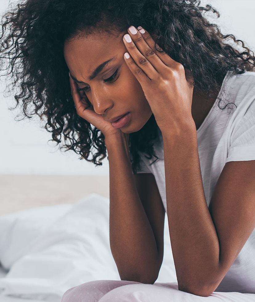 Photo of a woman experiencing strong migraines