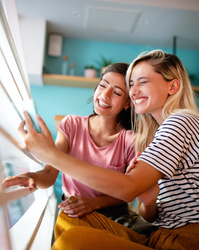 Photo of two smiling women posing for a selfie