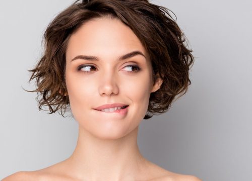 Photo of a woman with thin lips biting her lower lip
