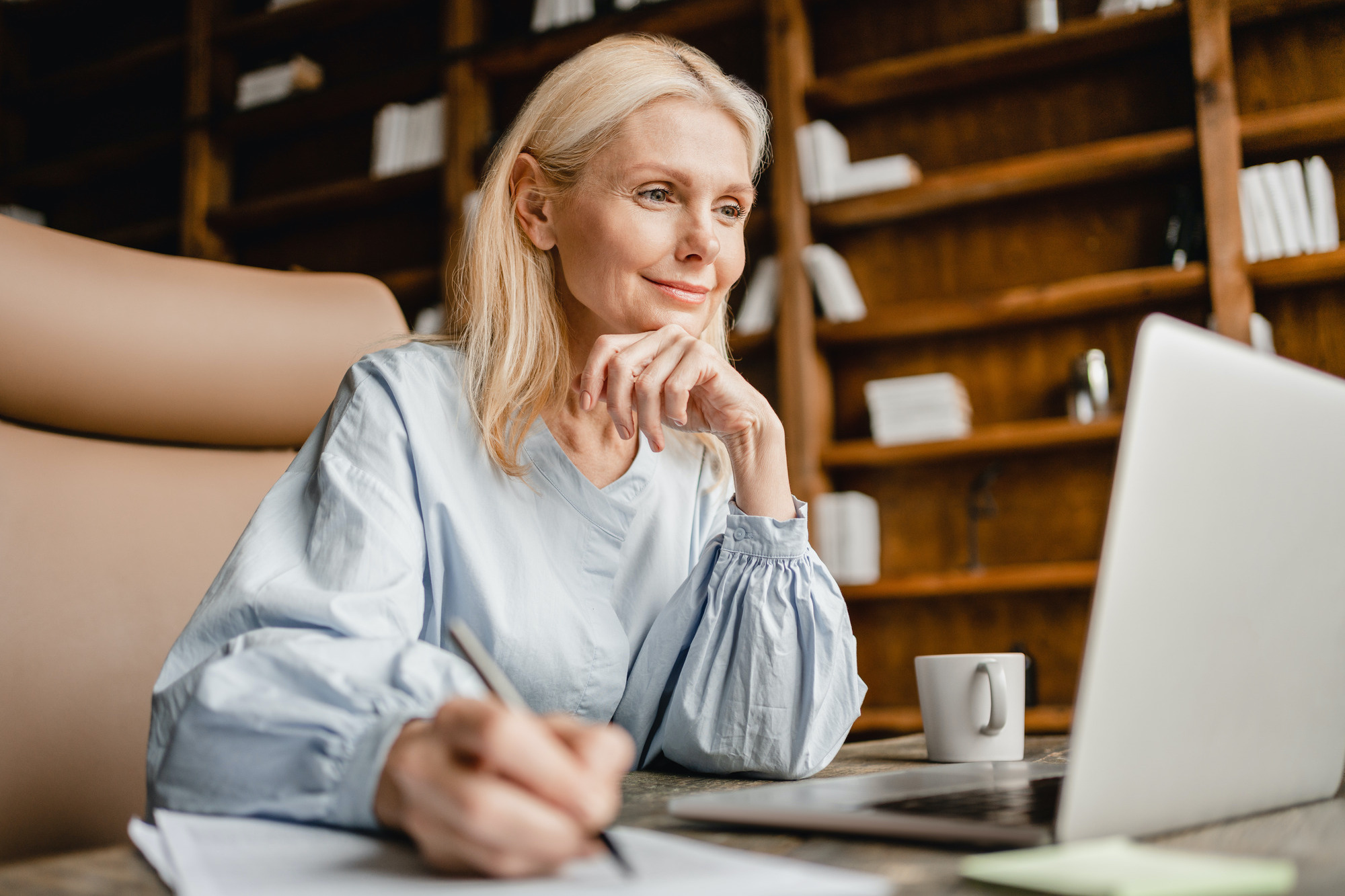 Photo of a beautiful older woman working at her desk