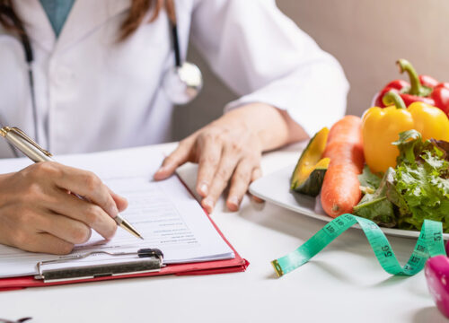 Photo of a doctor prepping for a medical weight loss session with a patient