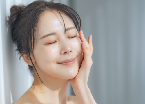 Woman standing inside a skincare clinic reception area