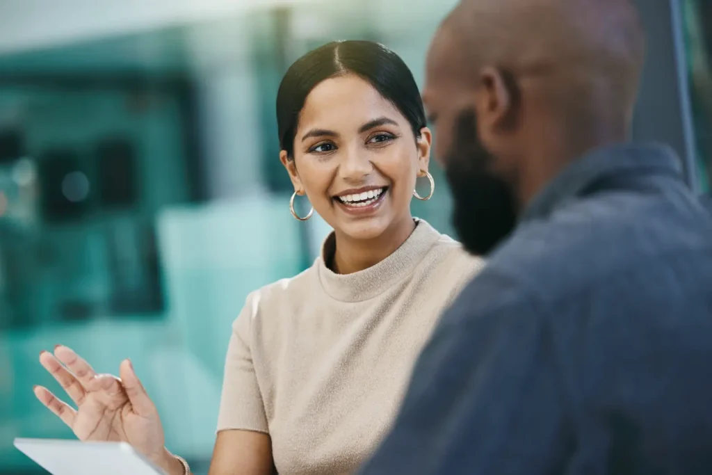 two professionals sitting and talking during a consultation