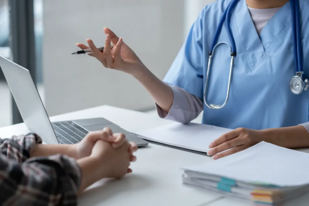 Healthcare provider speaking with patient during office consultation